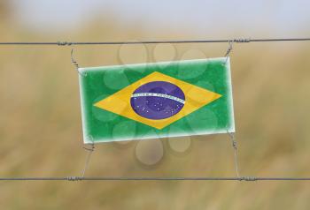 Border fence - Old plastic sign with a flag - Brazil