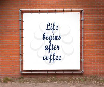 Large banner with inspirational quote on a brick wall - Life begins after coffee