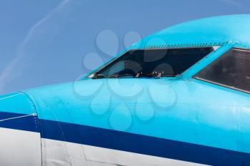 Cockpit close up of blue jet airplane