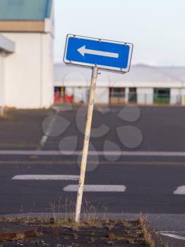 Traffic sign arrow pointing left, sign on an abandoned Amarican Airforce base on Iceland