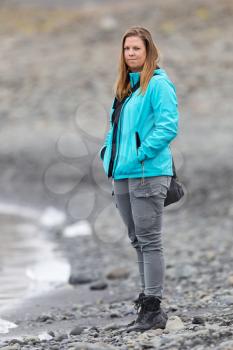 Woman walking over the beach at Jokulsarlon glacier lagoon in southern Iceland