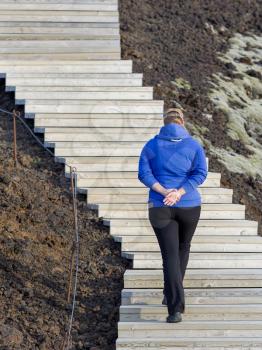 Shot of a young woman looking at the landscape while hiking in Iceland