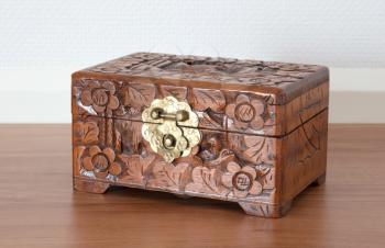 Very old wooden chest with simple lock, selective focus