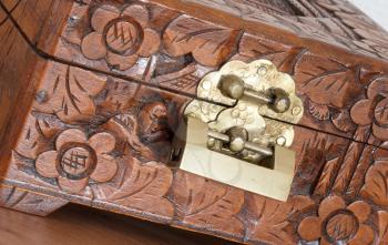 Very old wooden chest with simple lock, selective focus