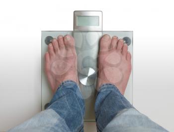 Closeup of man's feet on weight scale -