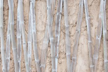 Bamboo texture in poured concrete wall, old african house