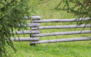 Wooden fence in the Alps -  Trees on the side