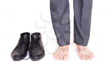 Businessman standing next to his shoes - Isolated