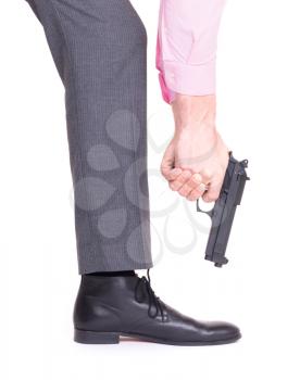 Concept - Businessman shooting himself in the foot with a handgun