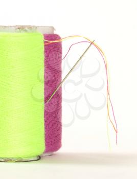 Color sewing thread with needle, isolated on a white background