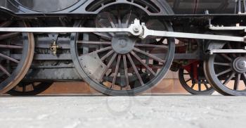 Steam locomotive wheels or steam train wheels and rods closeup for background