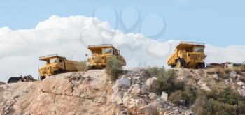 Old industrial trucks for stone waiting on a site in Greece