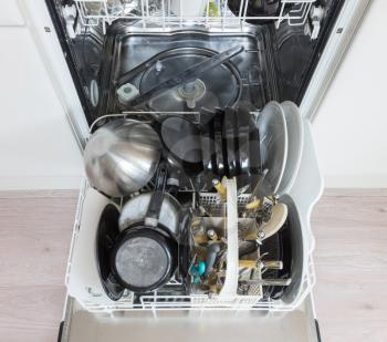 Open dishwasher with clean plates, cups and dishes - Selective focus