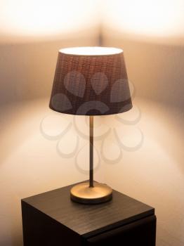 Table lamp standing on a large speaker - Light is on