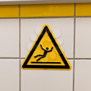 Warning sign for slippery floor - Tiled wall
