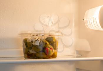 Olives in a refrigerator, selective focus on the olives