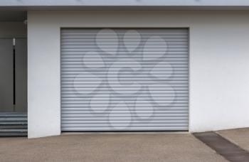 New door of a garage, empty street