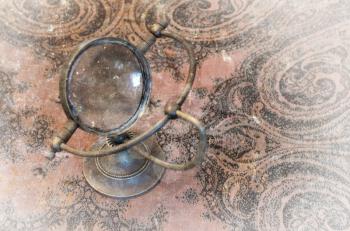 Vintage magnifier loupe  standing on a table  - Selective focus