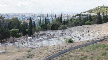 Athens, Greece - October 24, 2017: Panoramic view from the south slope of the Acropolis of Athens with the Theater of Dionysus Eleuthereus in the foreground and the city of Athens in the background.