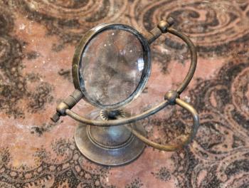Vintage magnifier loupe  standing on a table  - Selective focus