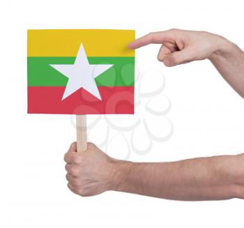Hand holding small card, isolated on white - Flag of Myanmar