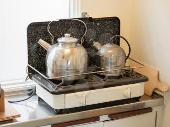 Simple teapot in a kitchen in a vintage train