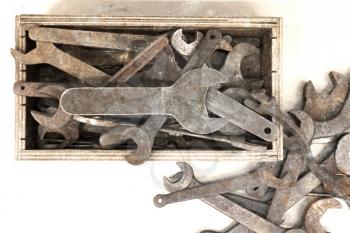 Collection of old rusty wrenches on a dirty floor