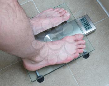 Closeup of man's feet on weight scale - Balance