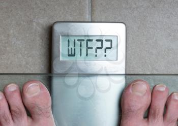 Closeup of man's feet on weight scale - WTF!!!