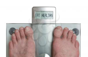 Closeup of man's feet on weight scale - Eat healthy