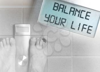 Closeup of man's feet on weight scale - Balance your life