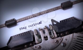 Stay curious, written on an old typewriter, vintage