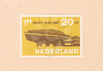 THE NETHERLANDS 1960: A stamp printed in the Netherlands shows a building in the city of Delft, circa 1960