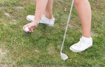 Golf ball on a golf track, woman playing