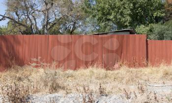 Red metal fence, protecting the property in Botswana