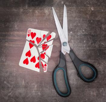 Concept of addiction, card with scissors, ten of hearts