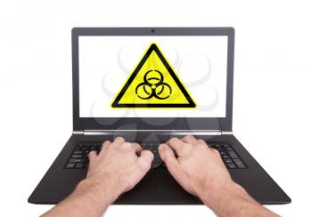 Man working on laptop, biohazard, isolated