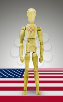 Old wood figure mannequin with US state flag bodypaint - New Mexico