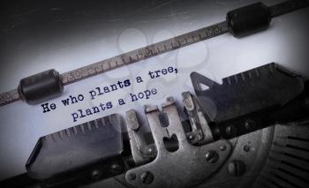 Vintage inscription made by old typewriter, He who plants a tree, plants a hope