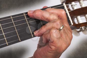 Old hand and guitar isolated on white background