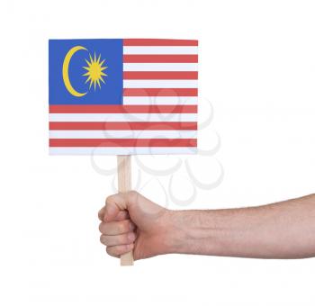 Hand holding small card, isolated on white - Flag of Malaysia