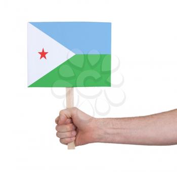 Hand holding small card, isolated on white - Flag of Djibouti