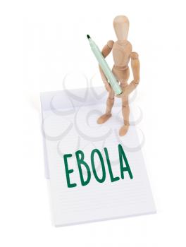 Wooden mannequin writing in a scrapbook - Ebola