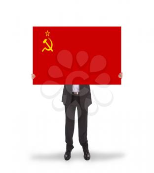 Smiling businessman holding a big card, flag of the USSR, isolated on white