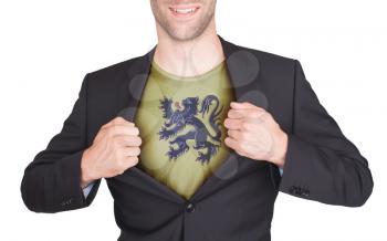 Businessman opening suit to reveal shirt with flag, Flanders