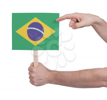 Hand holding small card, isolated on white - Flag of Brazil