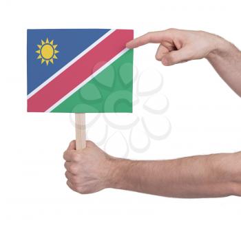 Hand holding small card, isolated on white - Flag of Namibia