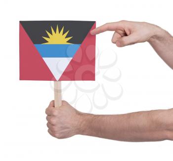 Hand holding small card, isolated on white - Flag of Antigua and Barbuda