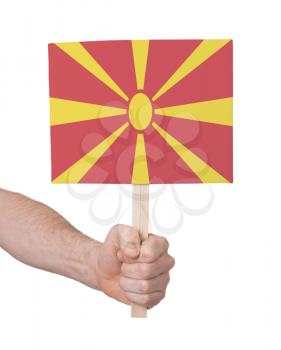 Hand holding small card, isolated on white - Flag of Macedonia