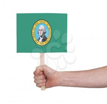 Hand holding small card, isolated on white - Flag of Washington